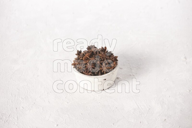 Star Anise in a white bowl on white background
