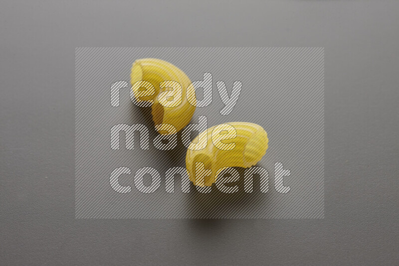 Elbow pasta on grey background