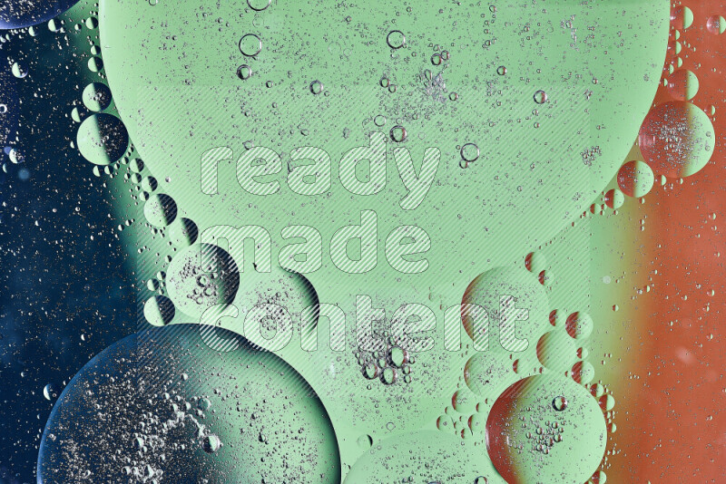 لقطات مقربة لفقاعات من الزيت على سطح الماء باللون البرتقالي والأخضر والأزرق