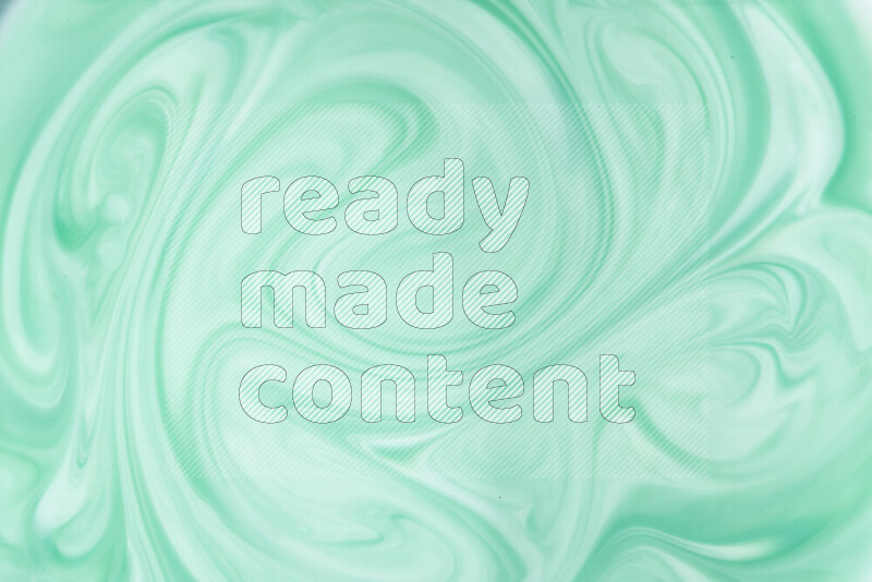 A close-up of abstract swirling patterns in green gradients