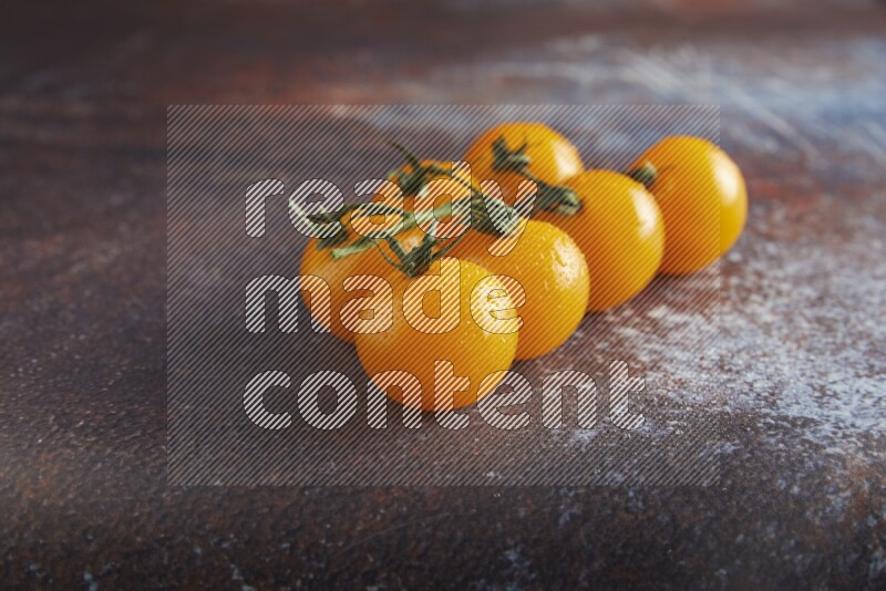 Yellow cherry tomato vein on reddish rustic metal background 45 degree