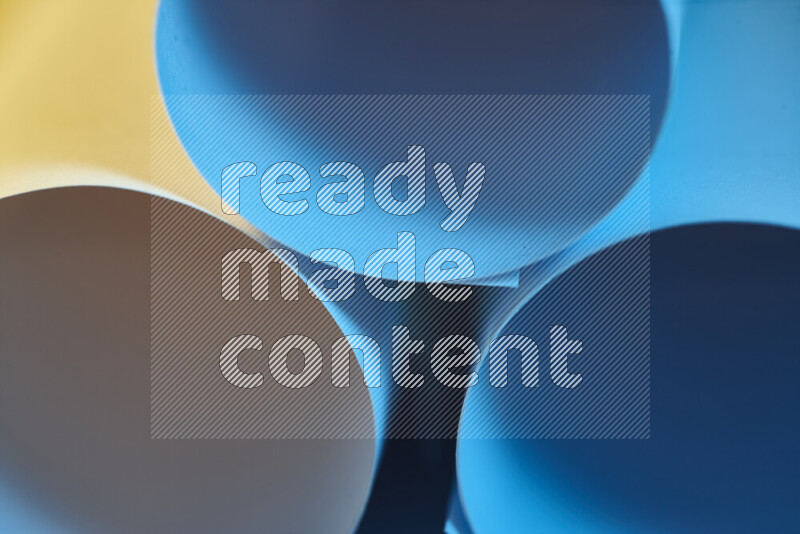 The image shows an abstract paper art with circular shapes in varying shades of blue and warm tones