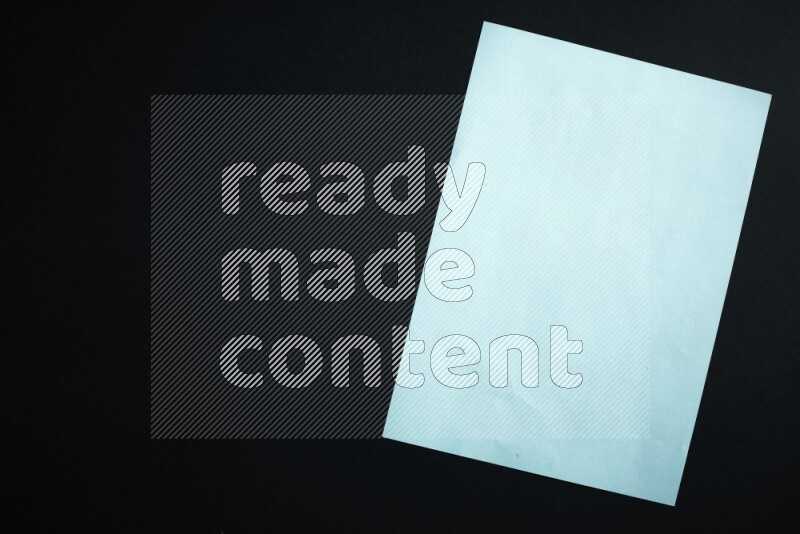 Multicolored paper sheet on black background