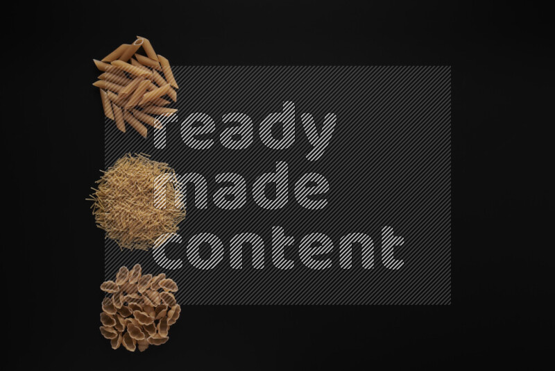 Different pasta types in 3 bunches on black background