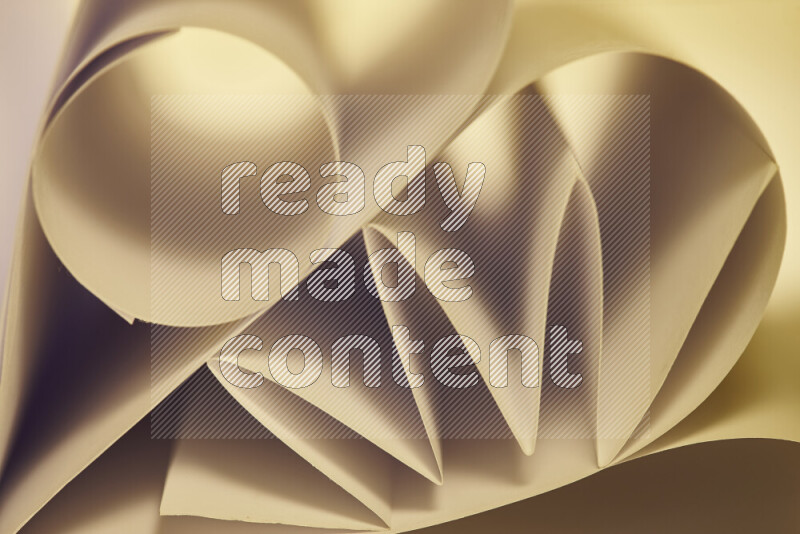 An artistic display of paper folds creating a harmonious blend of geometric shapes, highlighted by soft lighting in warm tones