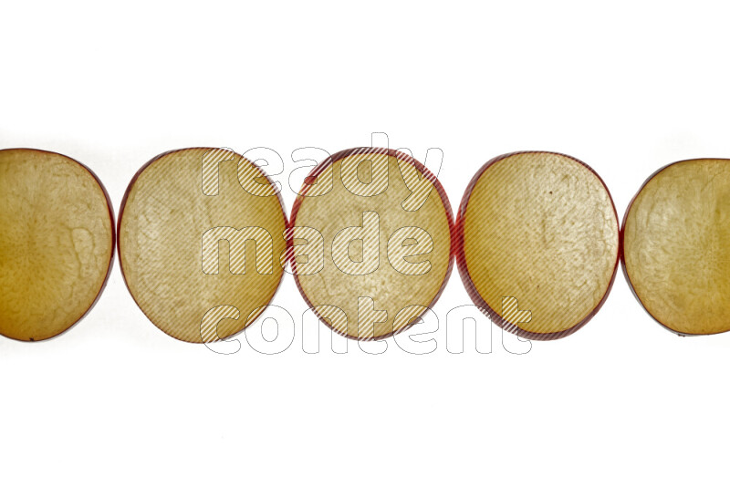 Plum slices on illuminated white background
