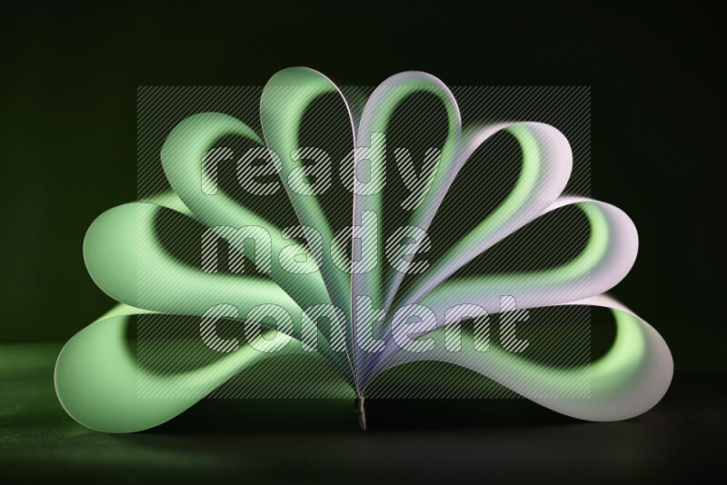 An abstract art piece displaying smooth curves in green and white gradients created by colored light