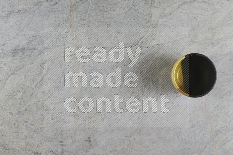 A multicolored pottery Bowl on grey marble background