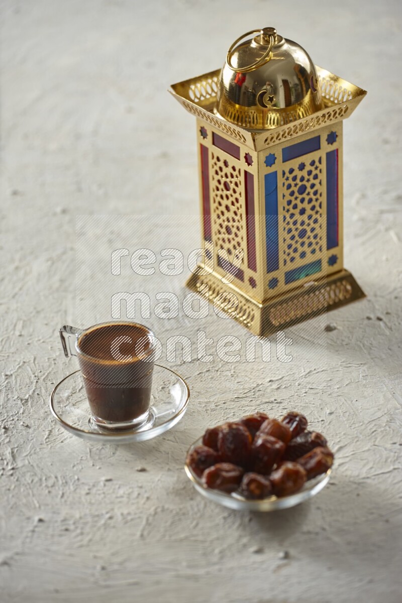 A golden lantern with different drinks, dates, nuts, prayer beads and quran on textured white background