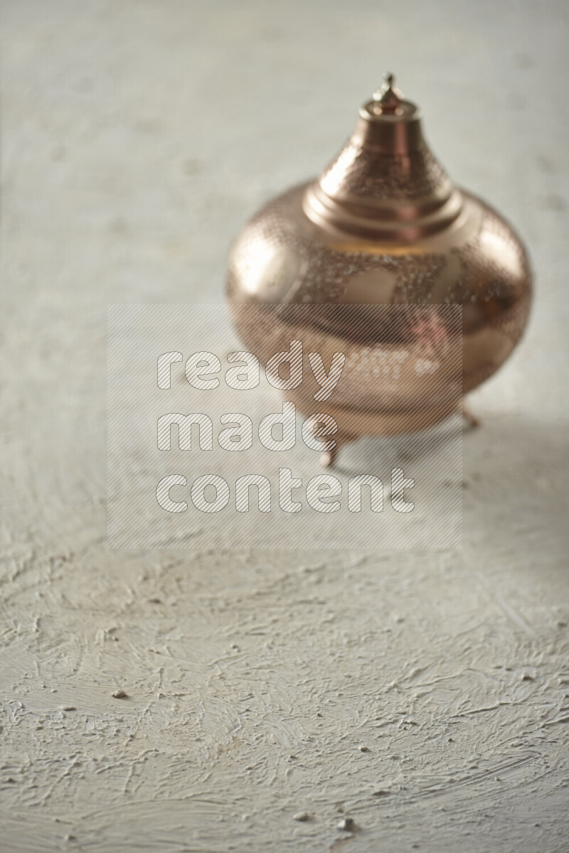 A lantern placed on a textured white background