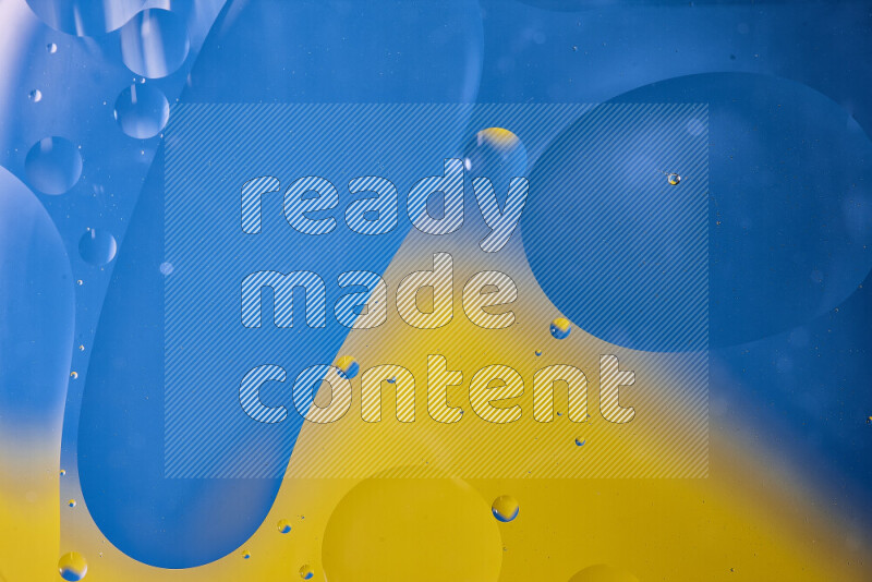 Close-ups of abstract oil bubbles on water surface in shades of blue and yellow