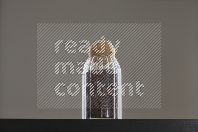 Buttons in a glass jar on black background