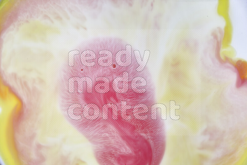 A close-up of abstract swirling patterns in yellow, red and white