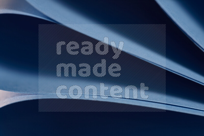 An abstract art showing blue paper sheets arranged in an overlapping curves