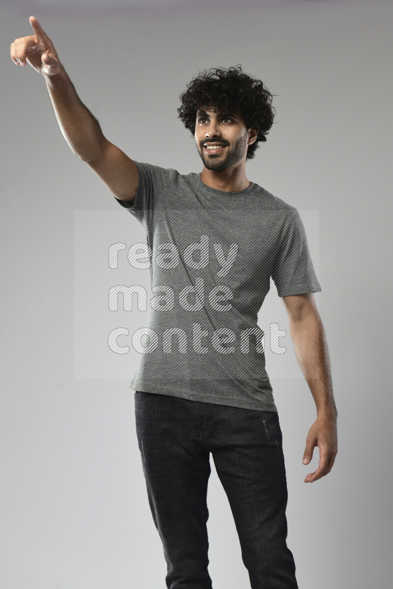 A man wearing casual standing and making a hand gesture on white background
