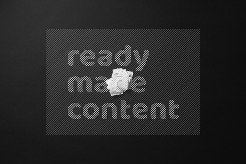 Ripped notebook sheet on black background