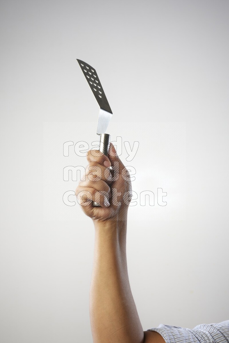 Male Hand Holding Burger Flipper on white background
