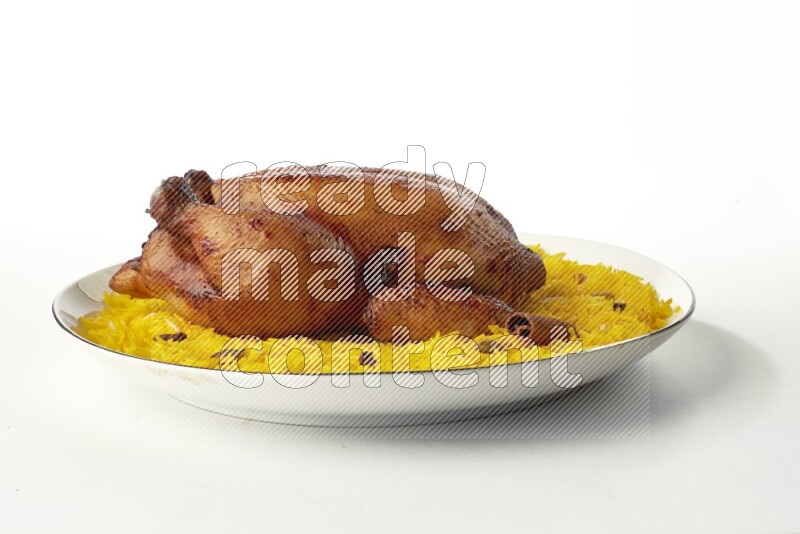 yellow  basmati Rice with kabsa chicken pieces on a white plate with a silver rim direct on white background