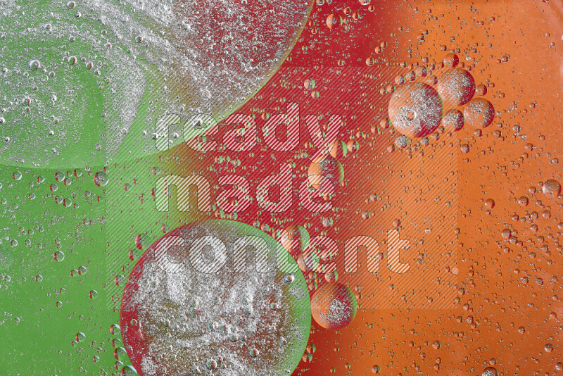 Close-ups of abstract oil bubbles on water surface in shades of orange, green and red