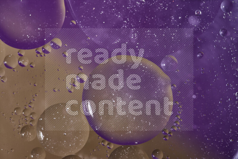 Close-ups of abstract oil bubbles on water surface in shades of purple and brown