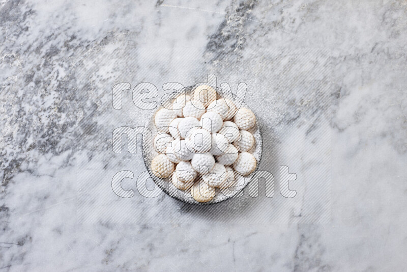 Kahk in black pottery plate on grey marble background