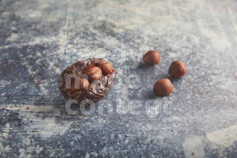 hazelnuts stuffed majdoul date on a rustic blue background