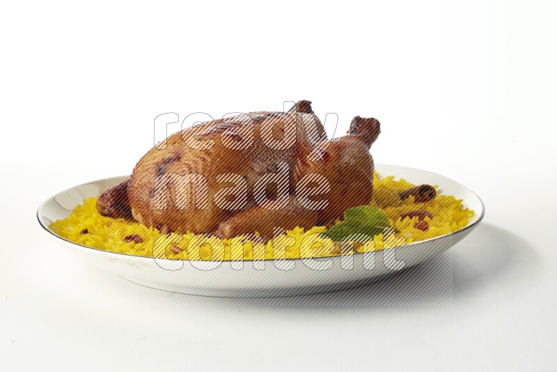 yellow  basmati Rice with kabsa chicken pieces on a white plate with a silver rim direct on white background