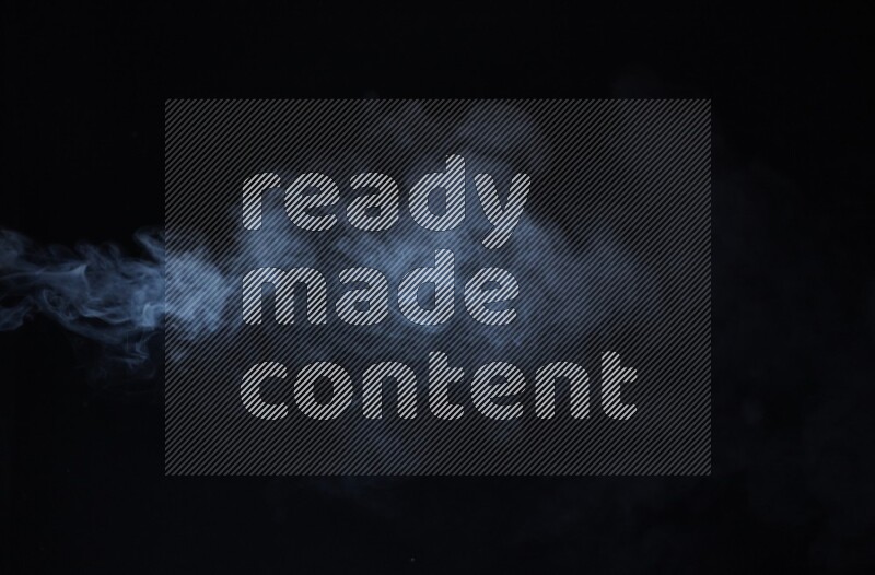 Heavy smoke in blue isolated on black background
