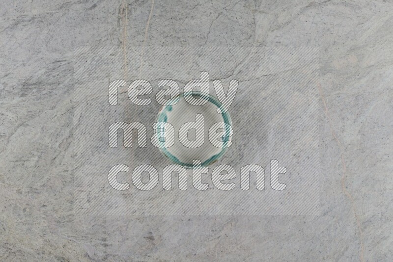 A multicolored pottery Bowl on grey marble background