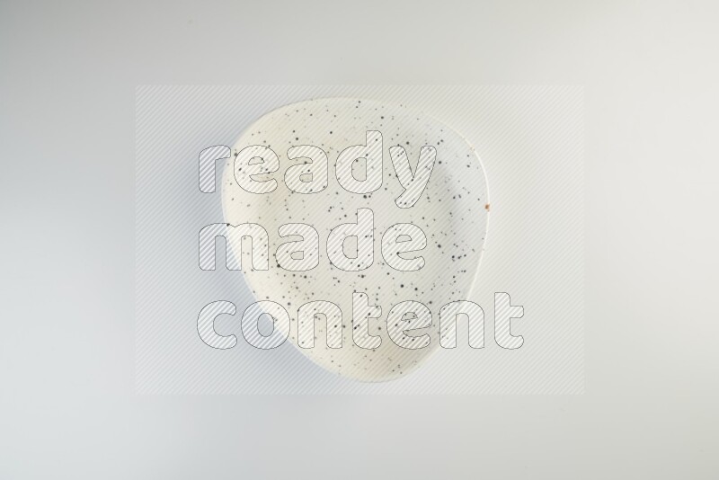 white plate with black dots on white background