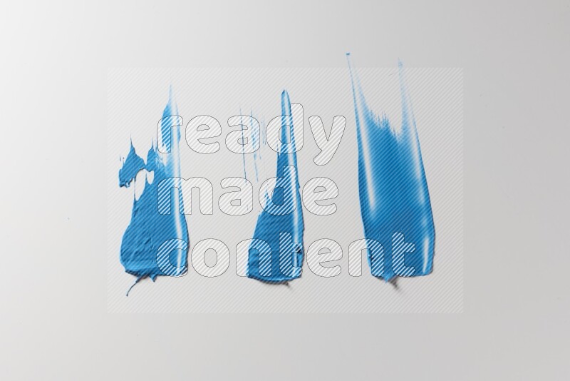 Blue painting knife strokes on a white background