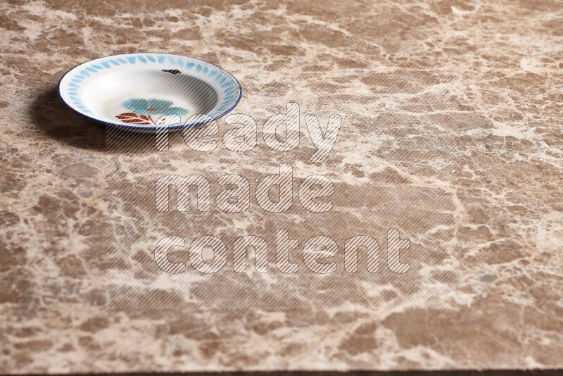 A vintage metal plate on beige marble background