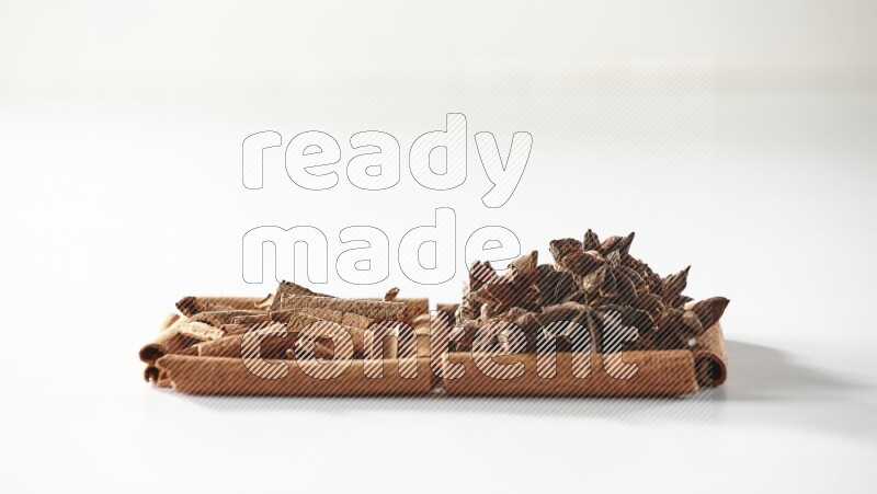 2 squares of cinnamon sticks full of star anise and cinnamon on white flooring