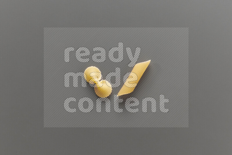 Fiocchi pasta with other types of pasta on grey background