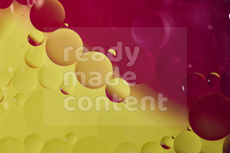 Close-ups of abstract oil bubbles on water surface in shades of red and yellow