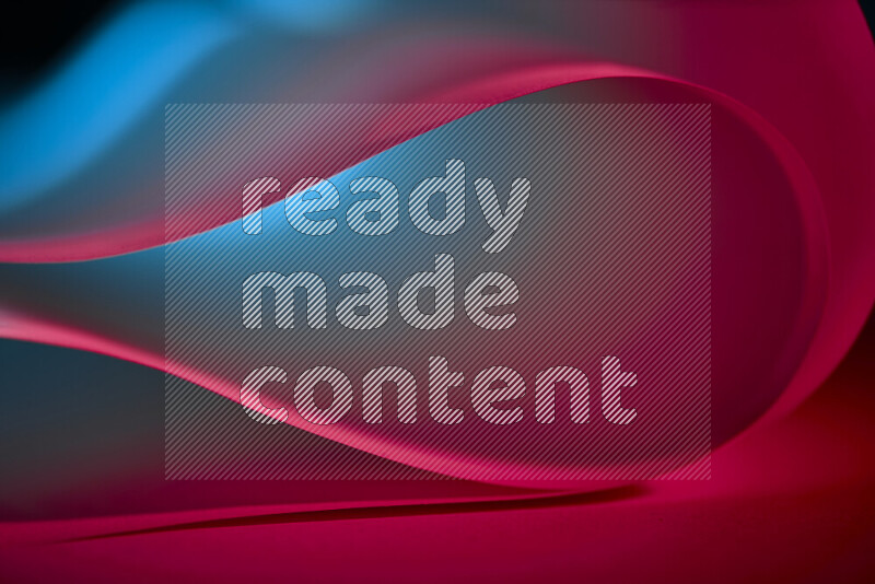 An abstract art piece displaying smooth curves in blue and red gradients created by colored light