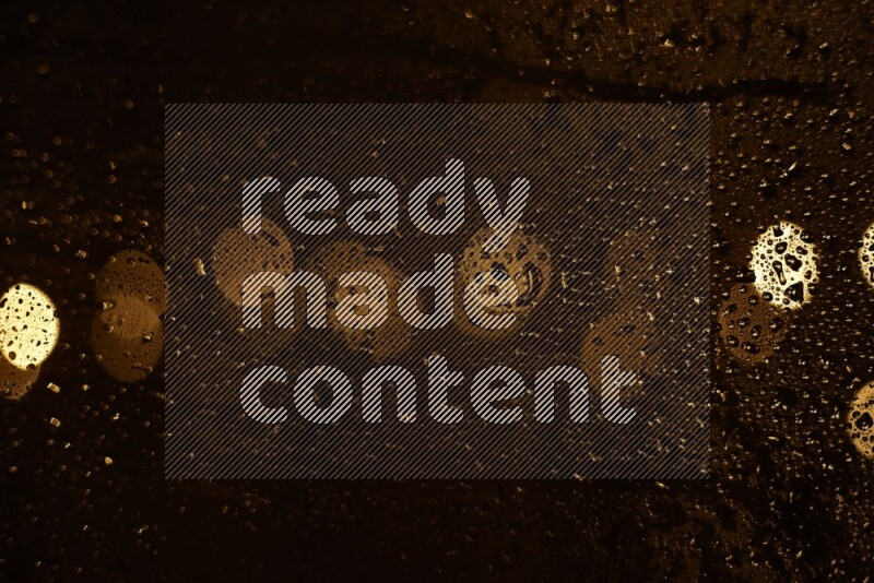 Bokeh light in yellow with water drops