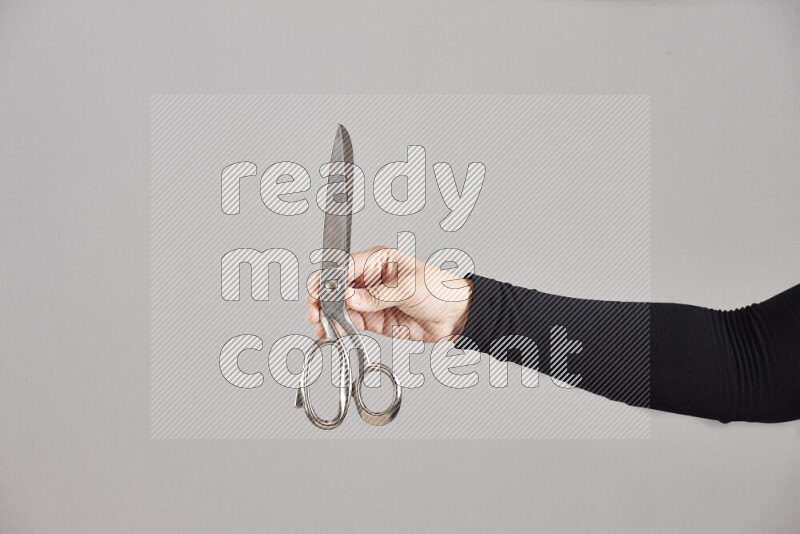 Woman hands holding different metal essentials in different positions
