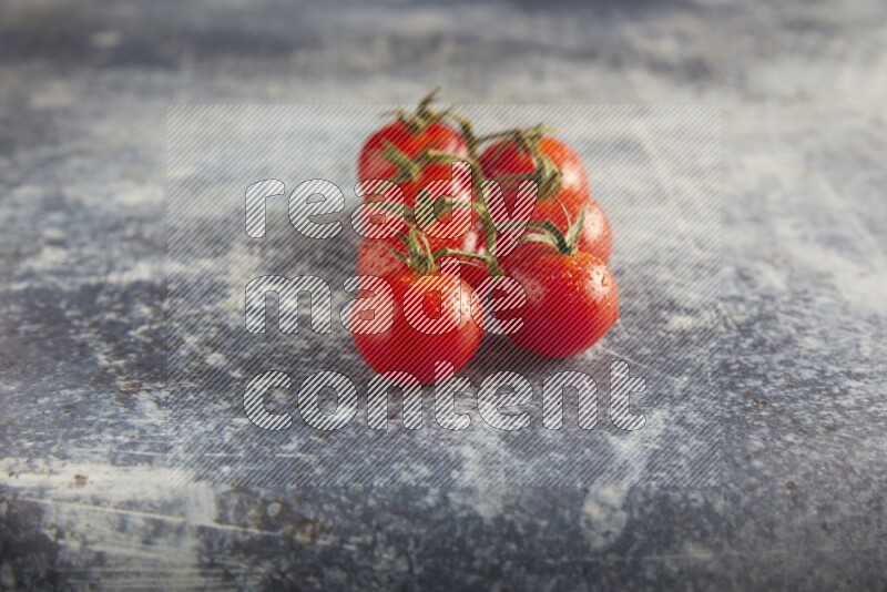 Red cherry tomato vein on a textured rusty blue background 45 degree