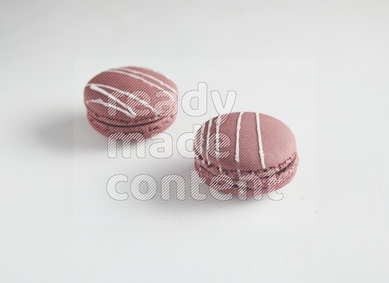 45º Shot of two Red Poppy Flower macarons on white background
