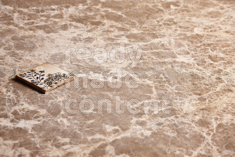 A decorative coaster on beige marble background