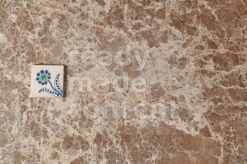 A decorative coaster on beige marble background