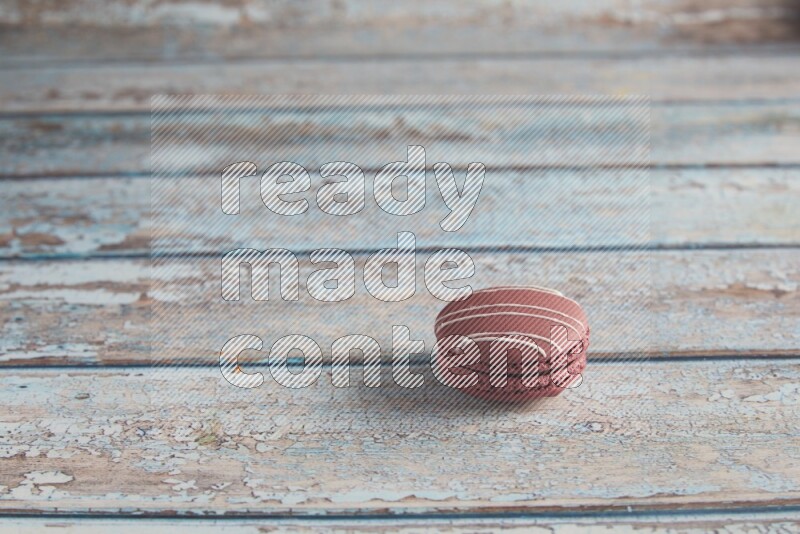 45º Shot of Red Poppy Flower macaron on light blue wooden background