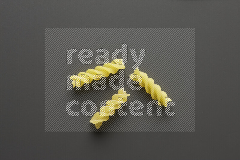 Fusilli pasta on grey background