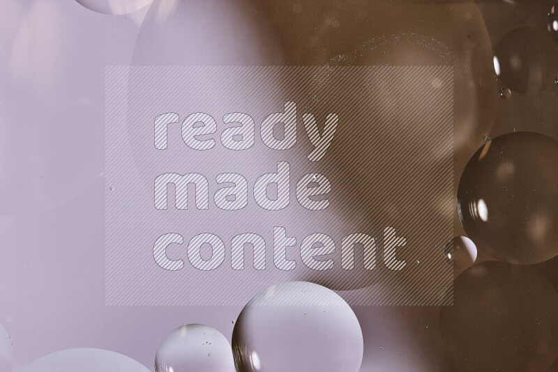 Close-ups of abstract oil bubbles on water surface in shades of white and brown