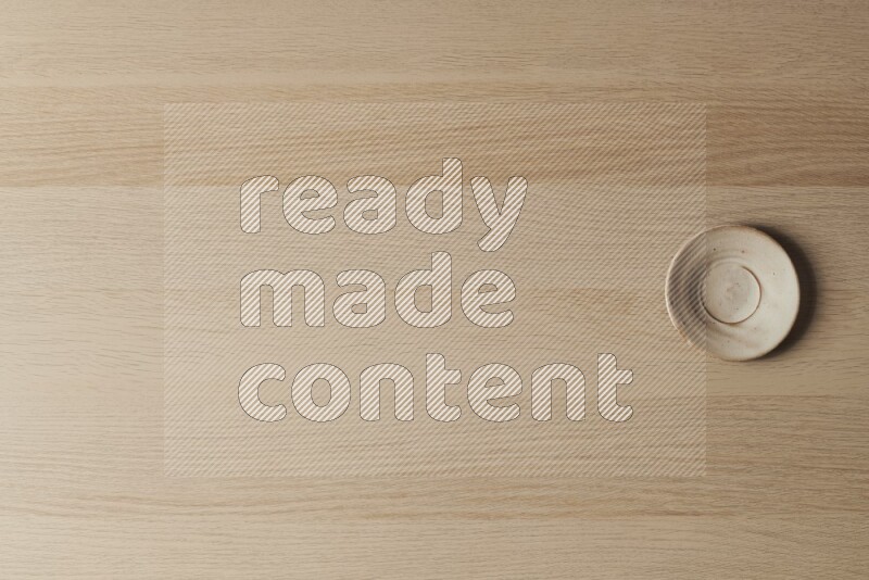 A pottery coaster on light wooden background