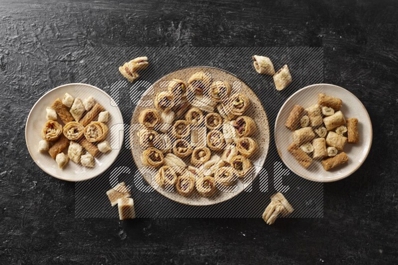 Oriental sweets in pottery plates in a dark setup