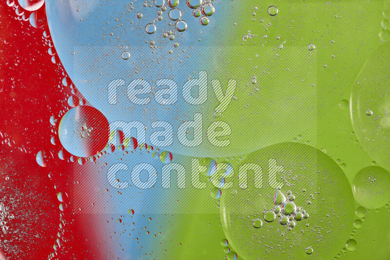 Close-ups of abstract oil bubbles on water surface in shades of red, green and blue