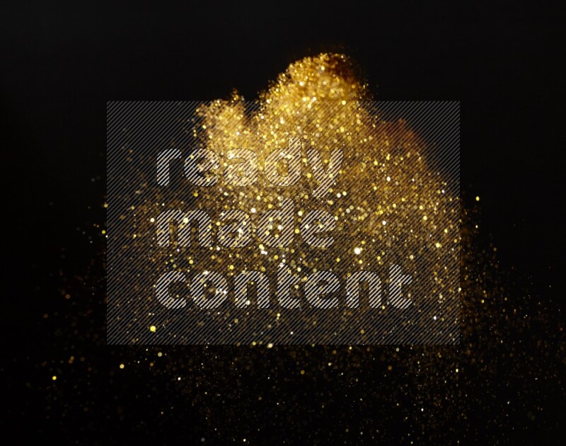 Gold glitter powder isolated on black background
