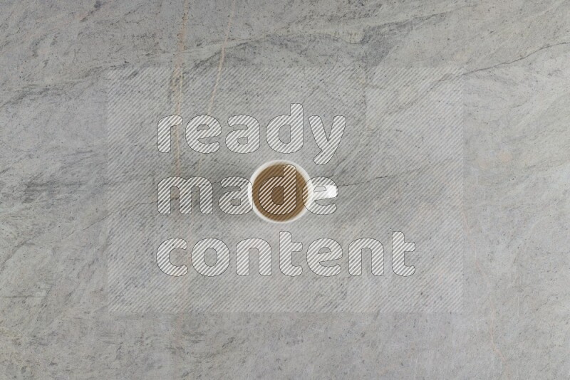 A multicolored pottery Cup on grey marble background